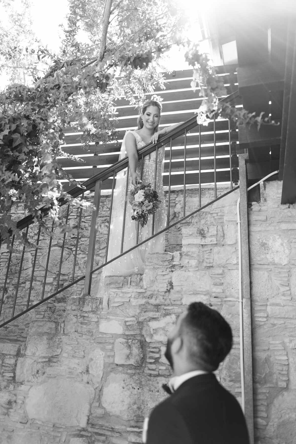 A couple in elegant wedding attire stand at the entrance of Ostium restaurant lounge with modern interior design and decor.