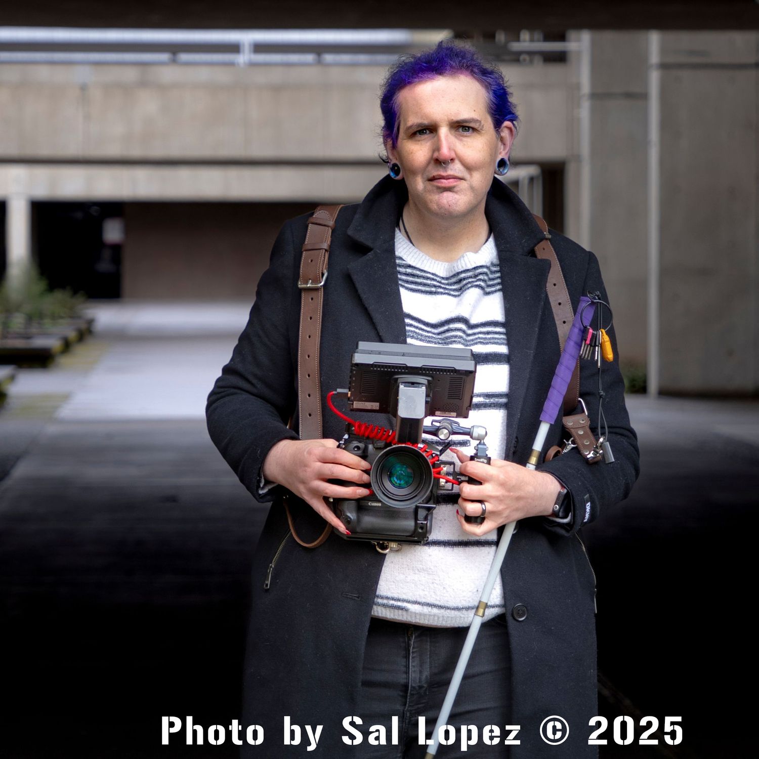 sal took this photo of me holding my giant camera and my cane