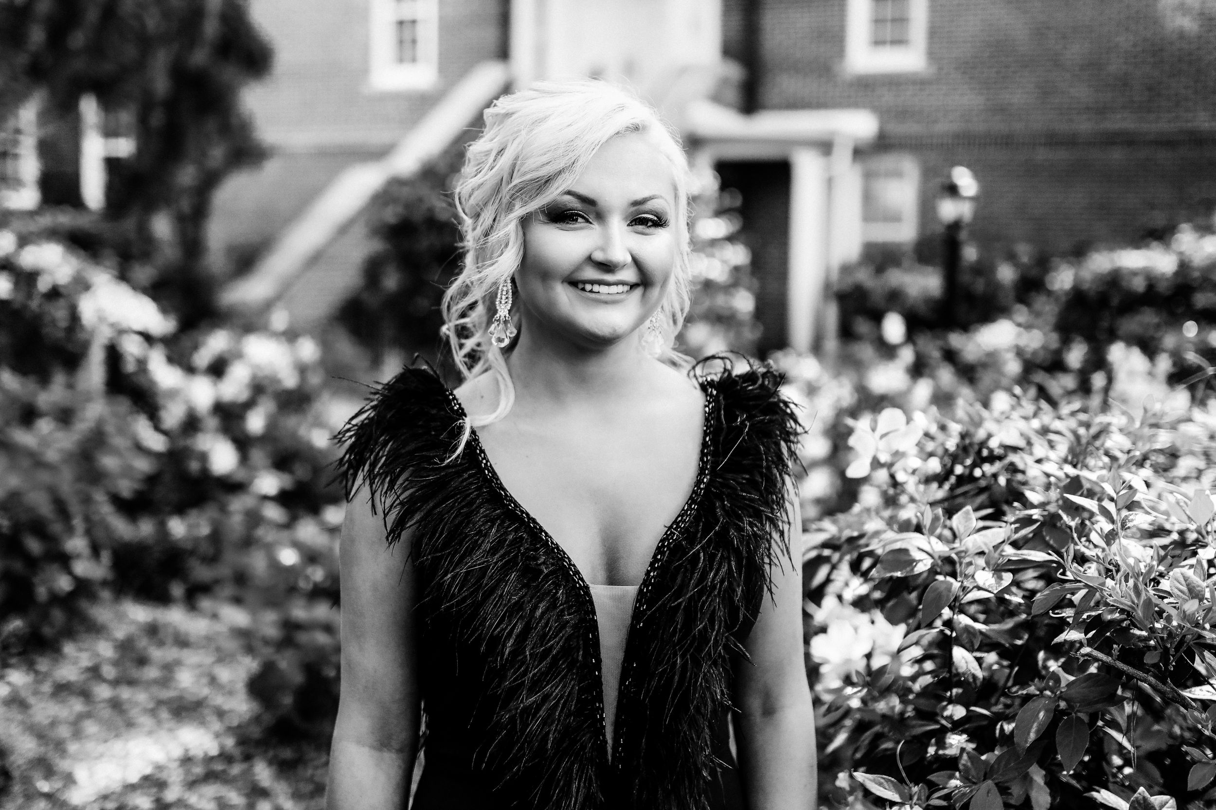 Black and white graduation photo in formal dress surrounded by trees and nature, in Amherstburg.