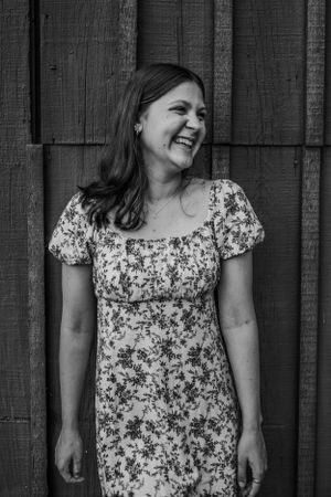 Girl looking away and laughing for senior session photography. Captured by Maryland Photographer Mallory Bramlett.