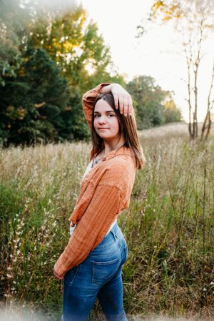 Girl in field for senior session photography. Captured by Maryland Photographer Mallory Bramlett.
