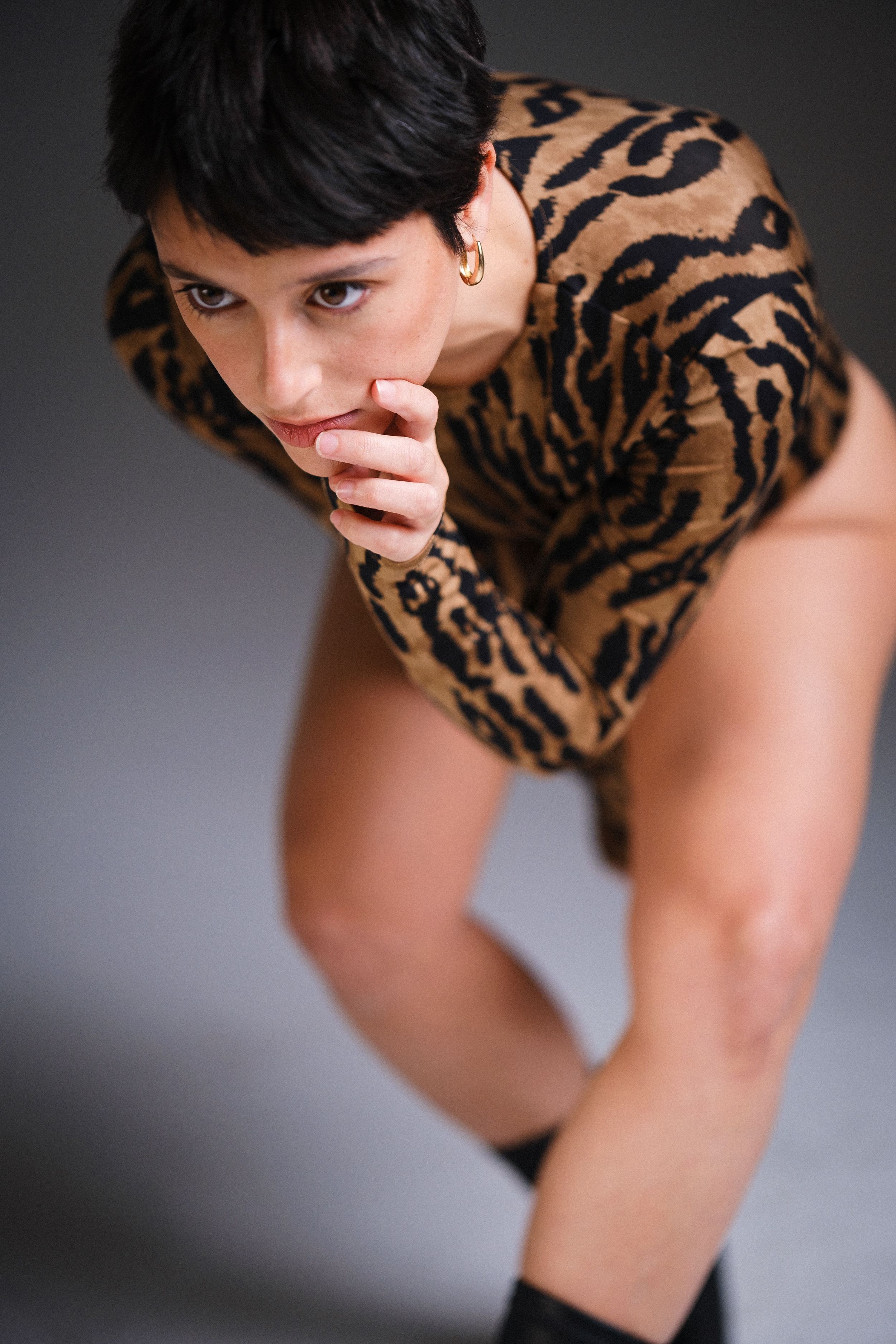 A dramatic low angle shot of someone wearing an animal print garment.