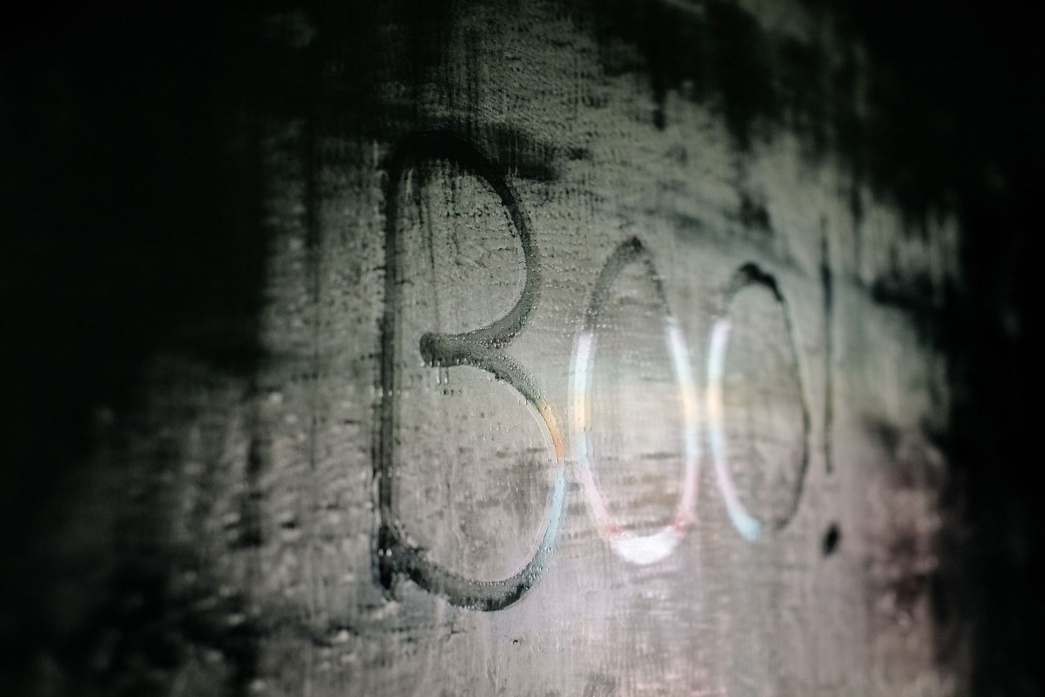 The number 300 written in graffiti style on a weathered concrete wall.
