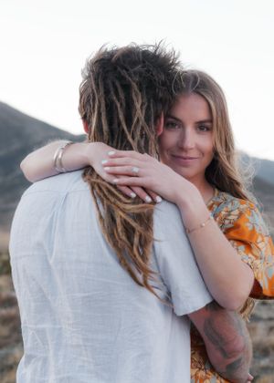 Intimate couple portraits showing tender moments and embraces against desert landscape.