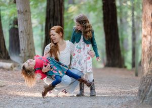 Four sequential photos show playful movements in a forest setting with redwood trees in the background.