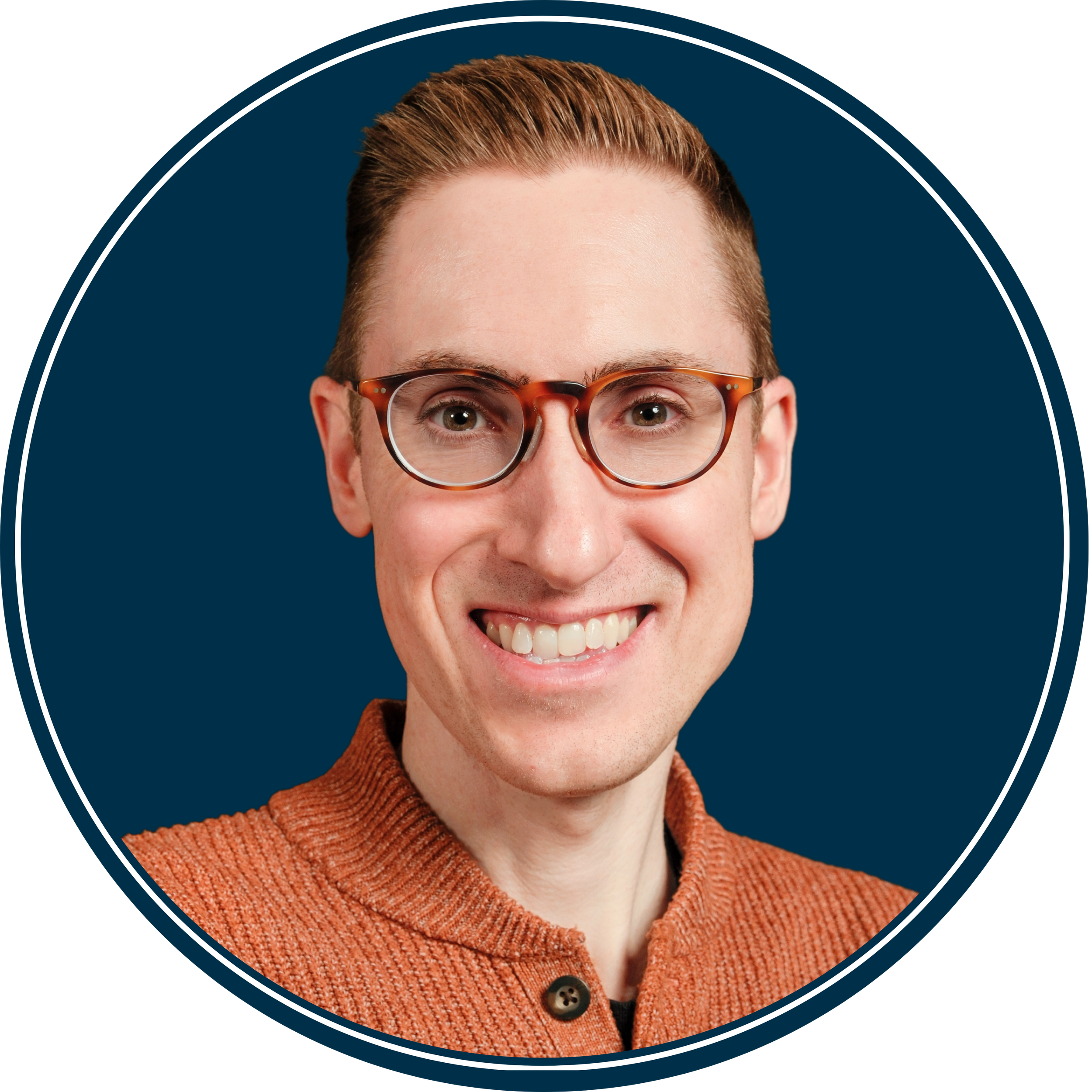 Professional headshot of a person wearing glasses and an orange sweater against a deep blue background.
