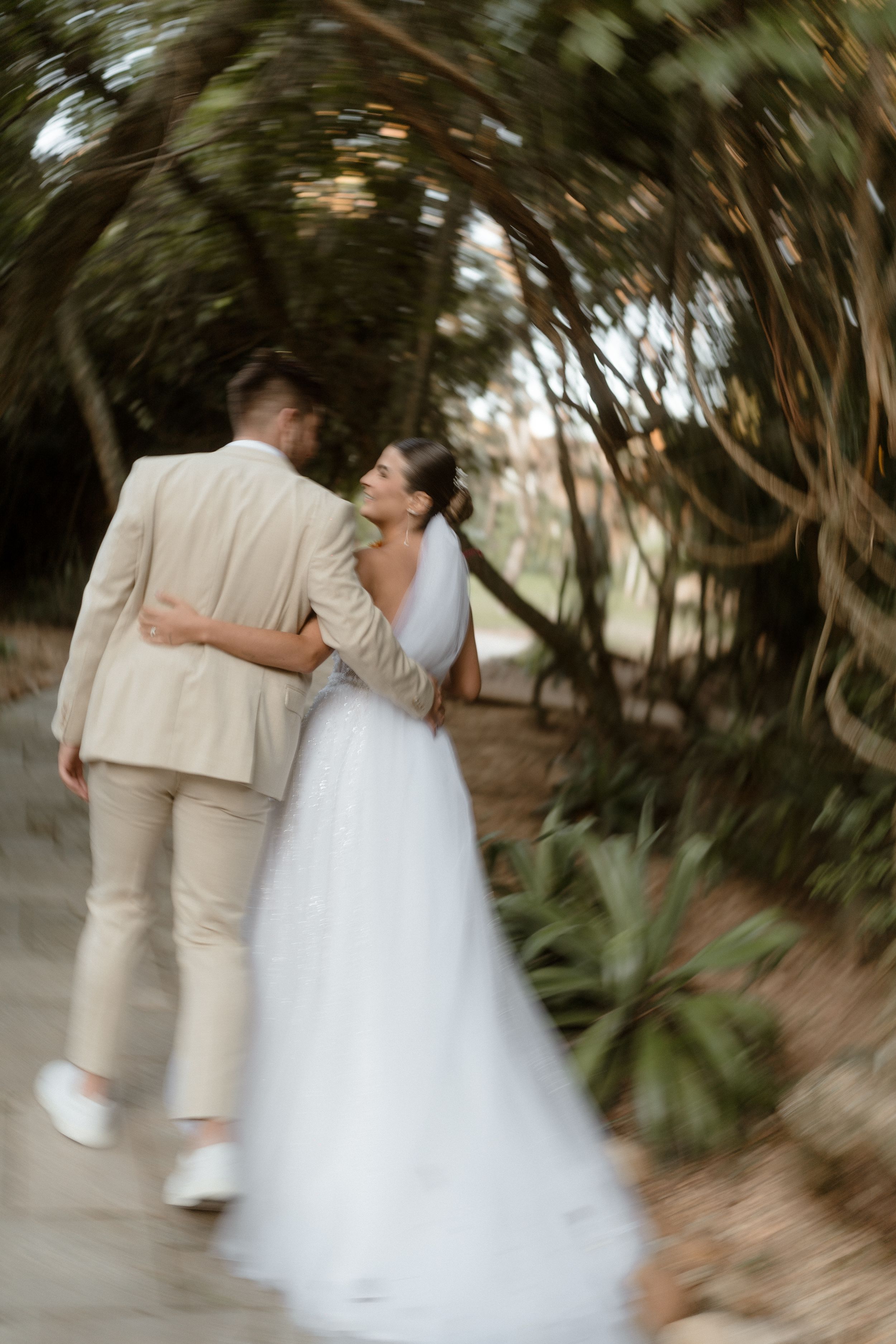 Motion-blurred romantic dance sequence in garden setting.