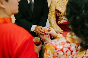 Bride and groom pouring tea during traditional wedding tea ceremony in Brisbane