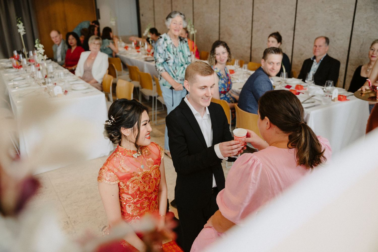 Bride and groom showing respect to elders during wedding tea ceremony in  The Calile Hotel