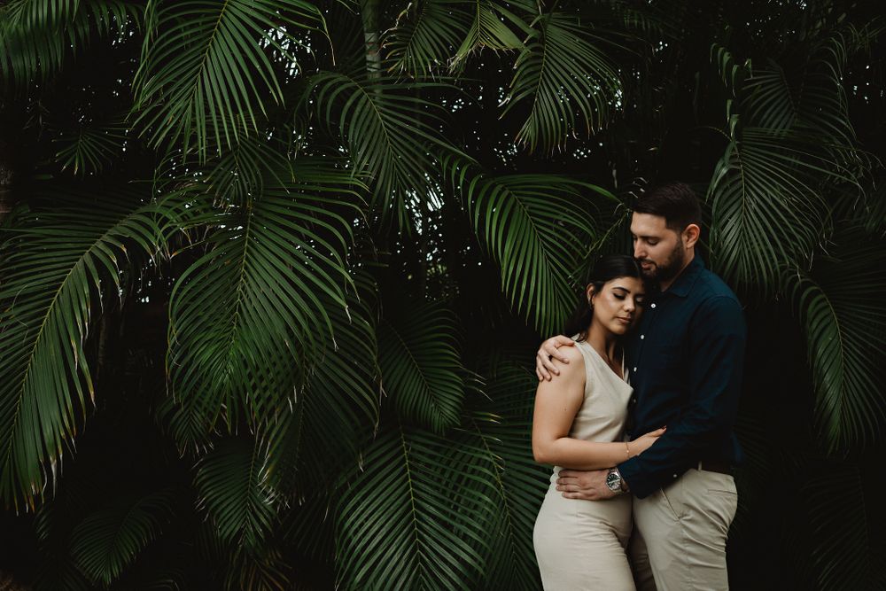 Couple embracing against a dark background, creating an artistic and intimate atmosphere