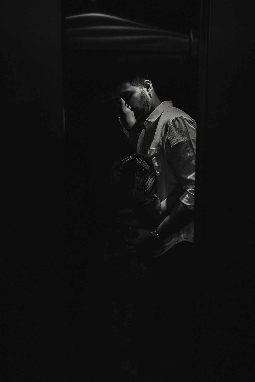A kiss in an elevator, an intimate, underexposed shot from their Mazatlán session