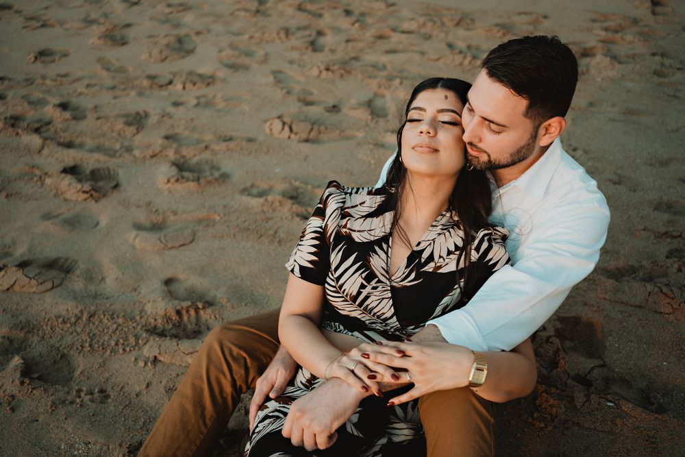 Sitting calmly in the sand, reflecting their peaceful bond on a serene Mazatlán day