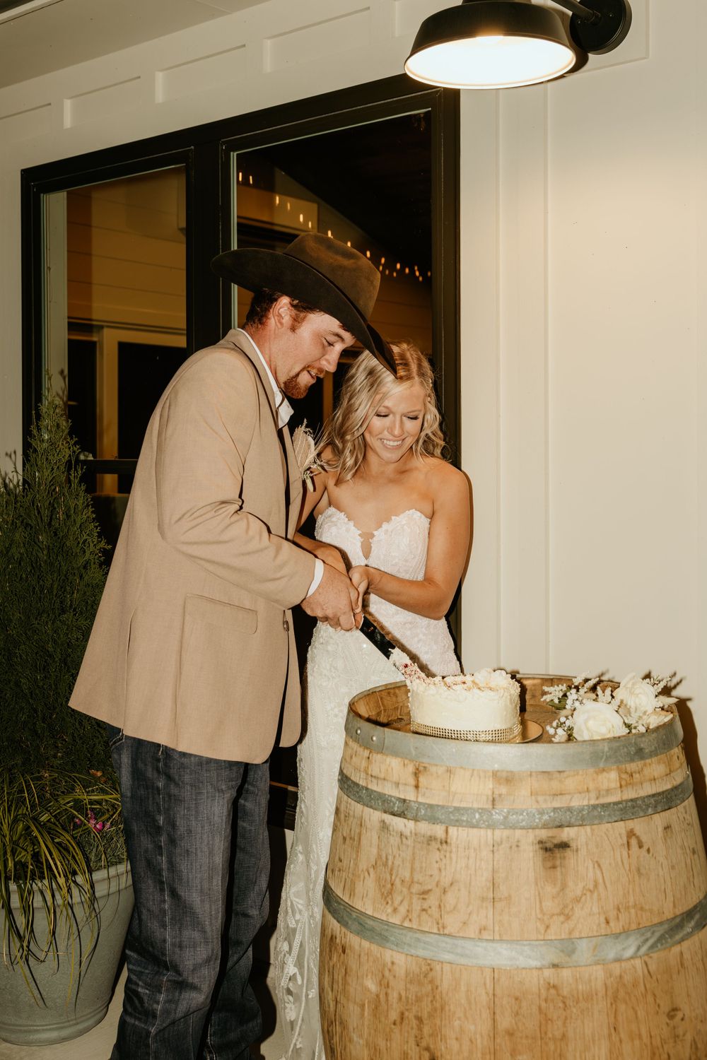 Photograph of bride and groom cutting cake at a wedding in Senoia, Georgia