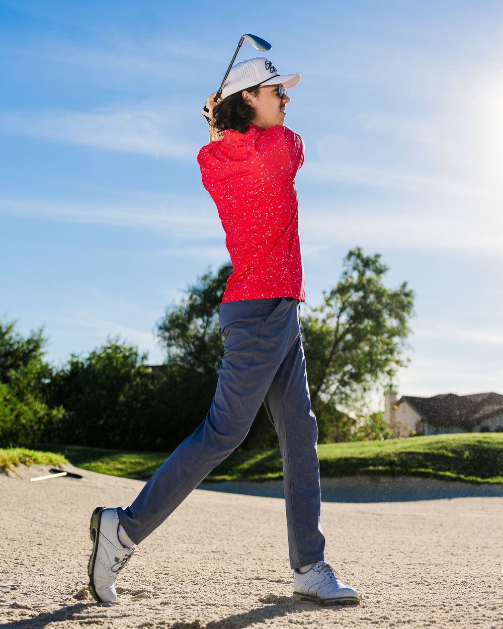 A sequence showing stretching exercises being performed on a gravel path with blue sky and trees in the background.