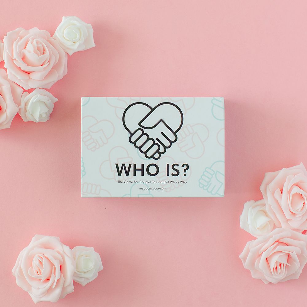 'Who Is' game card with handshake heart logo surrounded by pink roses on coral background.