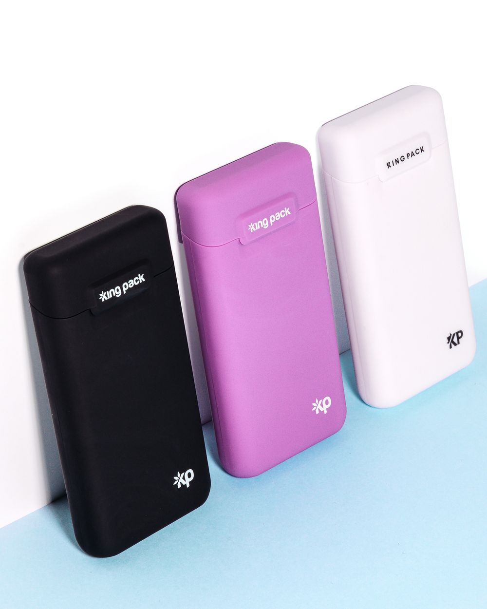 Collection of portable devices in black, pink, and white colors arranged on blue and white background.