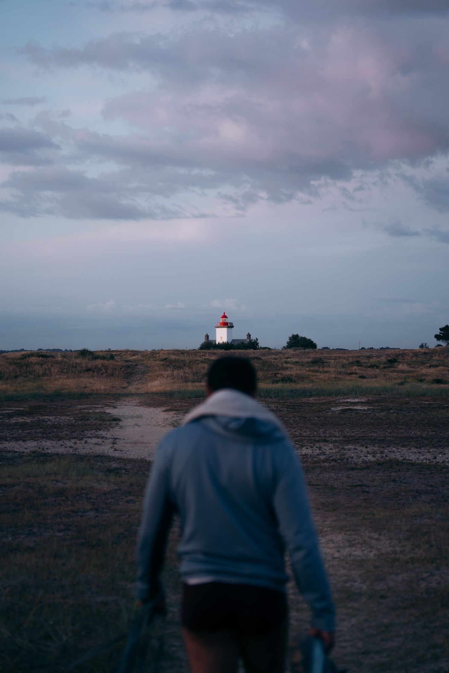 Promeneur au phare d'Agon Coutainville à la tombée de la nuit dans le département de la Manche en Normandie - Cotentin.