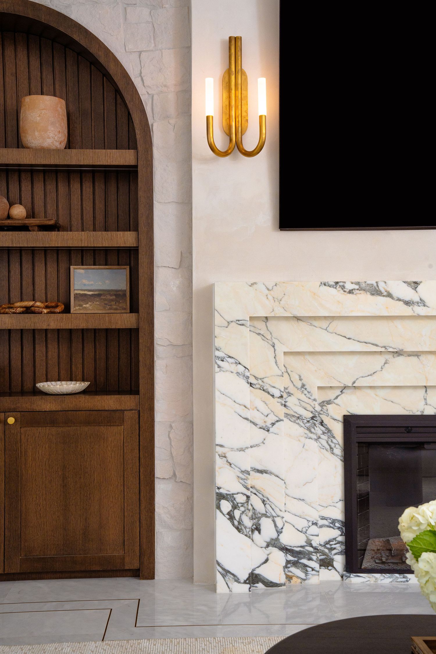 Modern white kitchen with floor to ceiling cabinets, island, and contemporary glass globe pendant light.