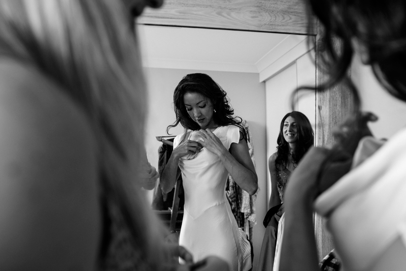 A candid moment during wedding preparations captured in black and white.