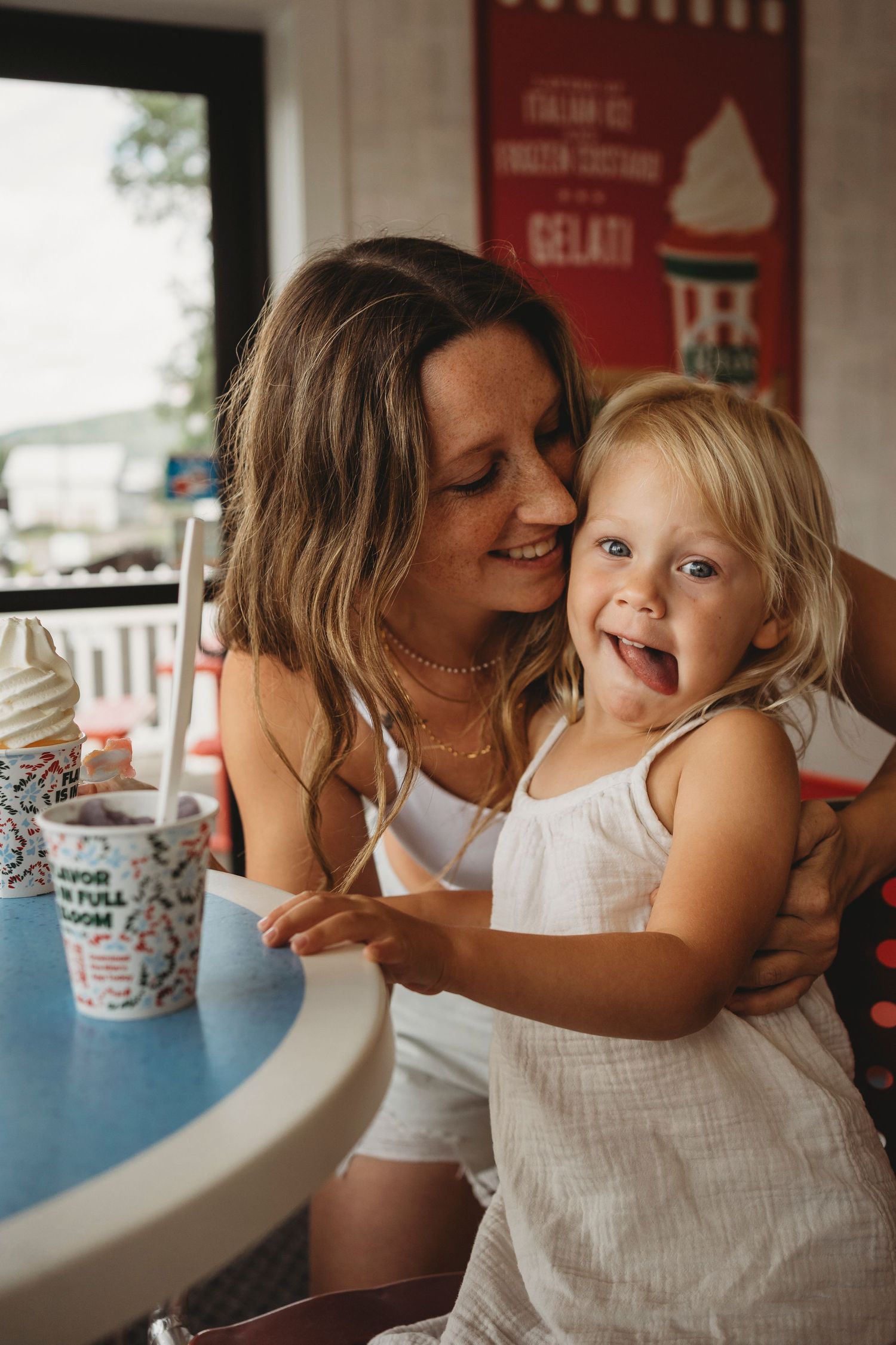 Sweet candid moment sharing ice cream at an outdoor dessert shop.
