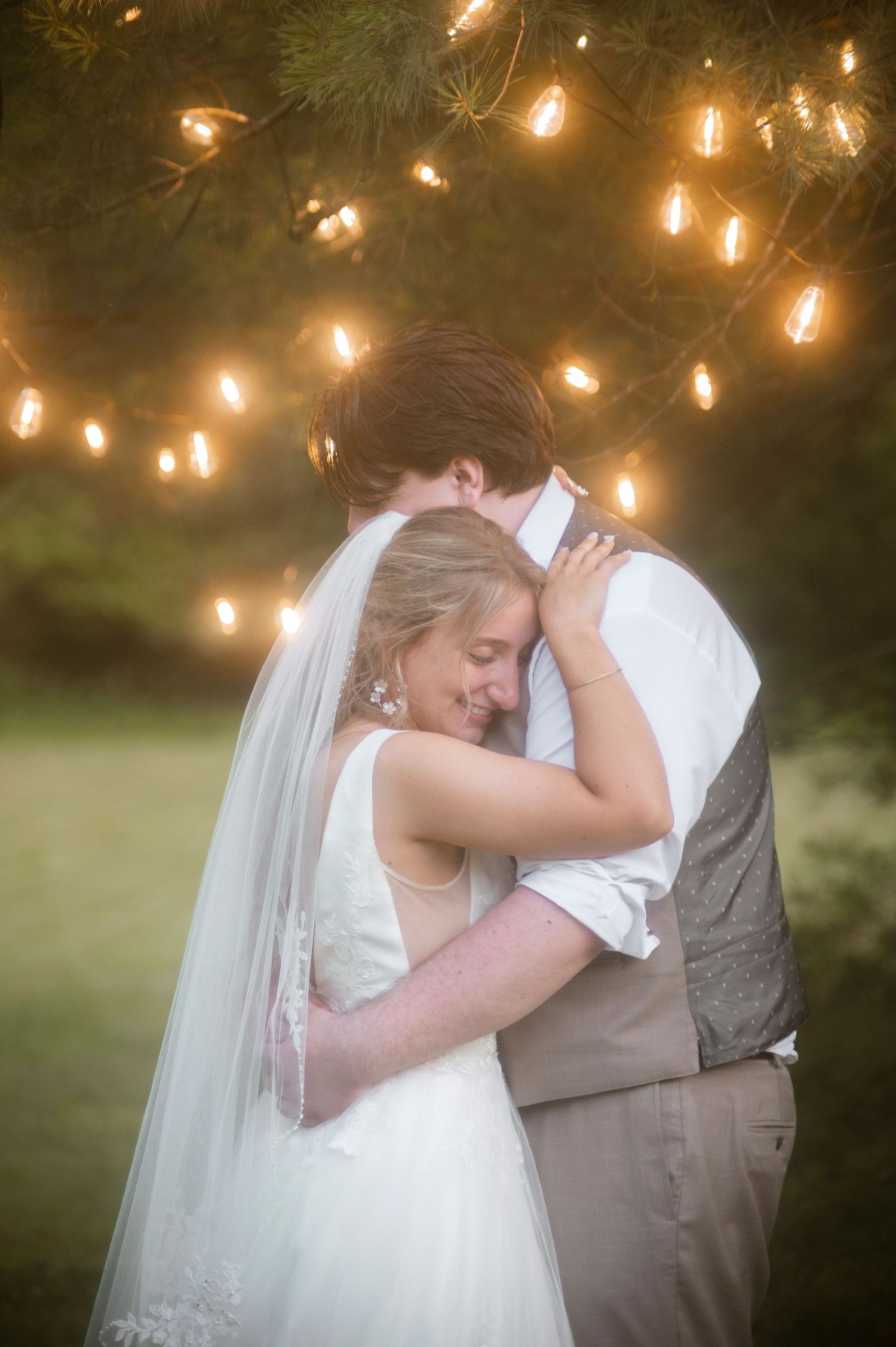 A romantic kiss under sparklers at a nighttime celebration.