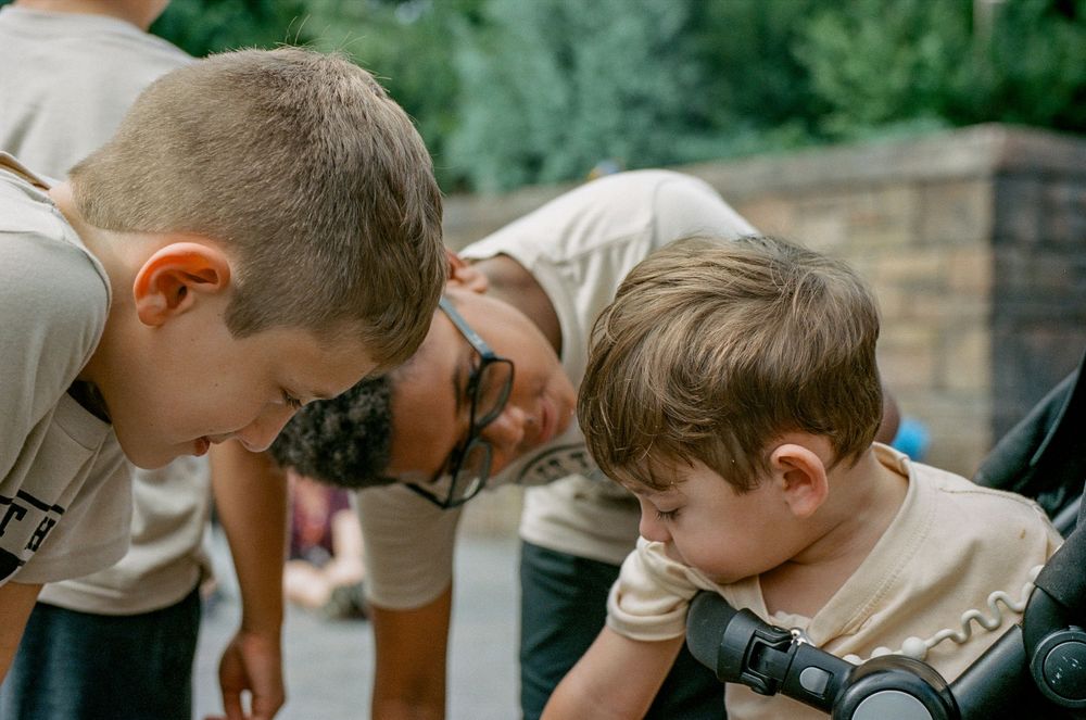 Two people examining something intently at a theme park attraction.