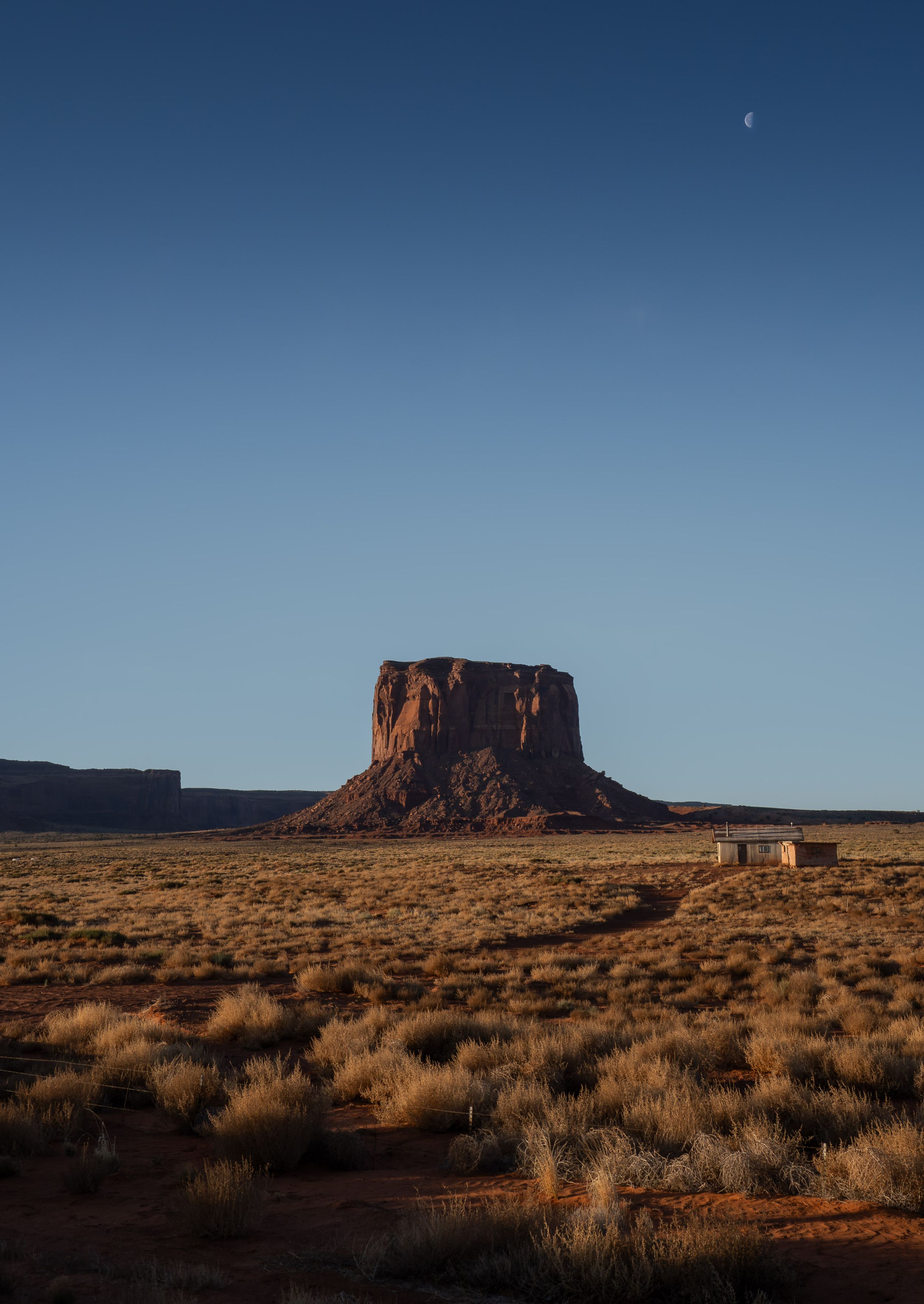 A panoramic sequence of Monument Valley's iconic buttes and desert landscape at sunset with golden light across the horizon.
