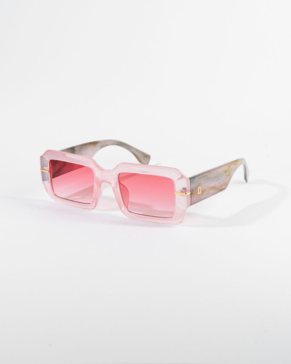 Clear frame rectangular sunglasses with pink gradient lenses on white backdrop. Mtlshutter photography