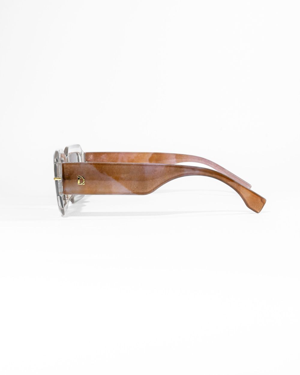 Side view of brown gradient sunglasses frame showing transparent temple design. Mtlshutter photography