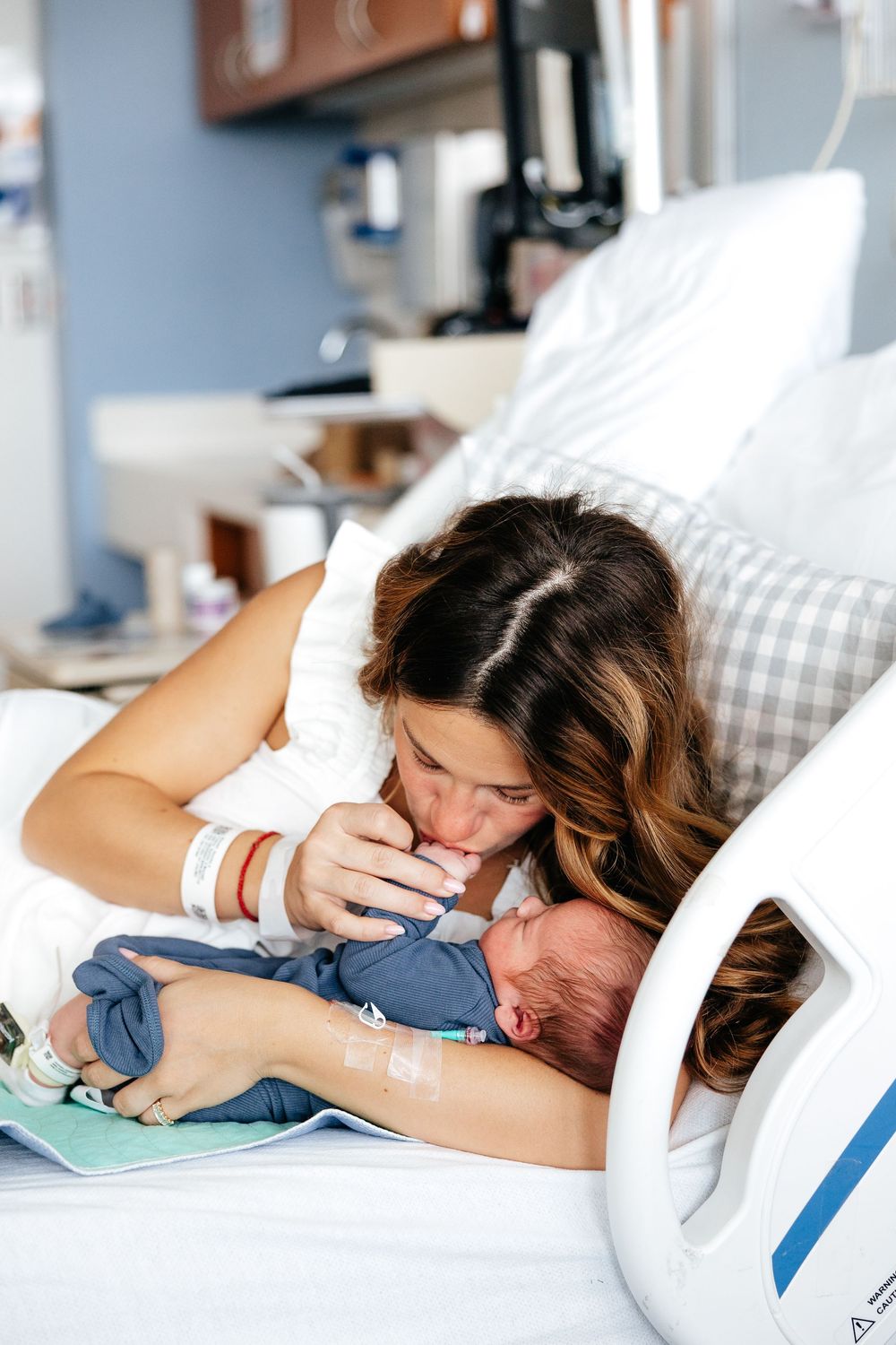 A couple sharing tender moments while resting together on a hospital bed.