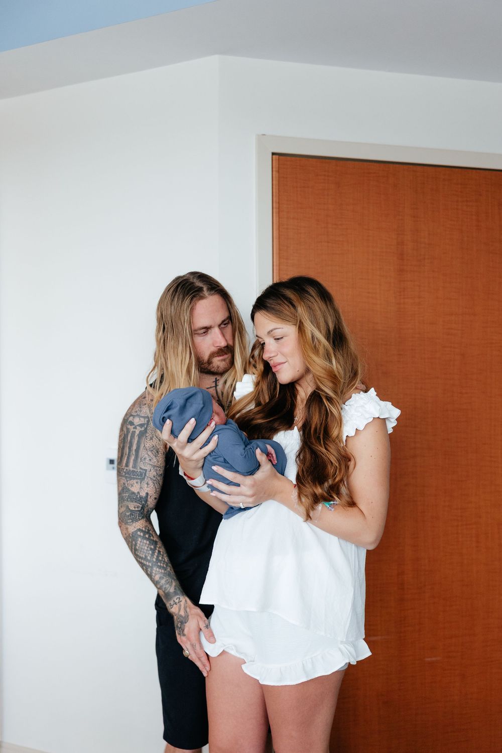 A couple shares intimate moments with their baby in a series of tender indoor portraits.