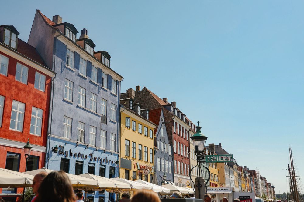 Colorful historic buildings lining the famous Nyhavn canal waterfront in Copenhagen, Denmark.