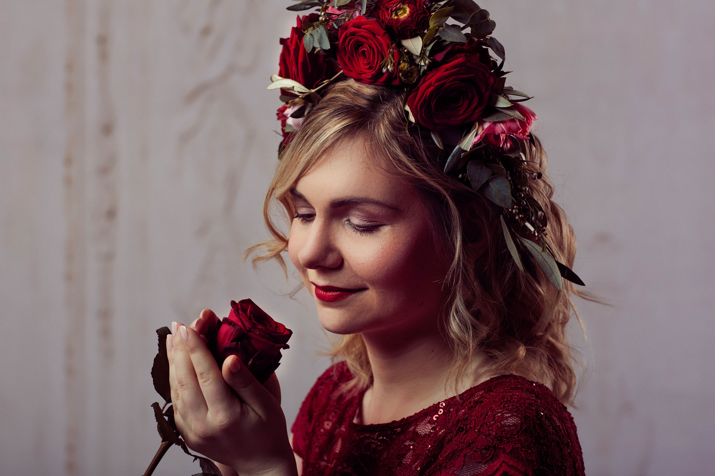 Woman holding a beautiful crimson rose - learn to be careful who to trust