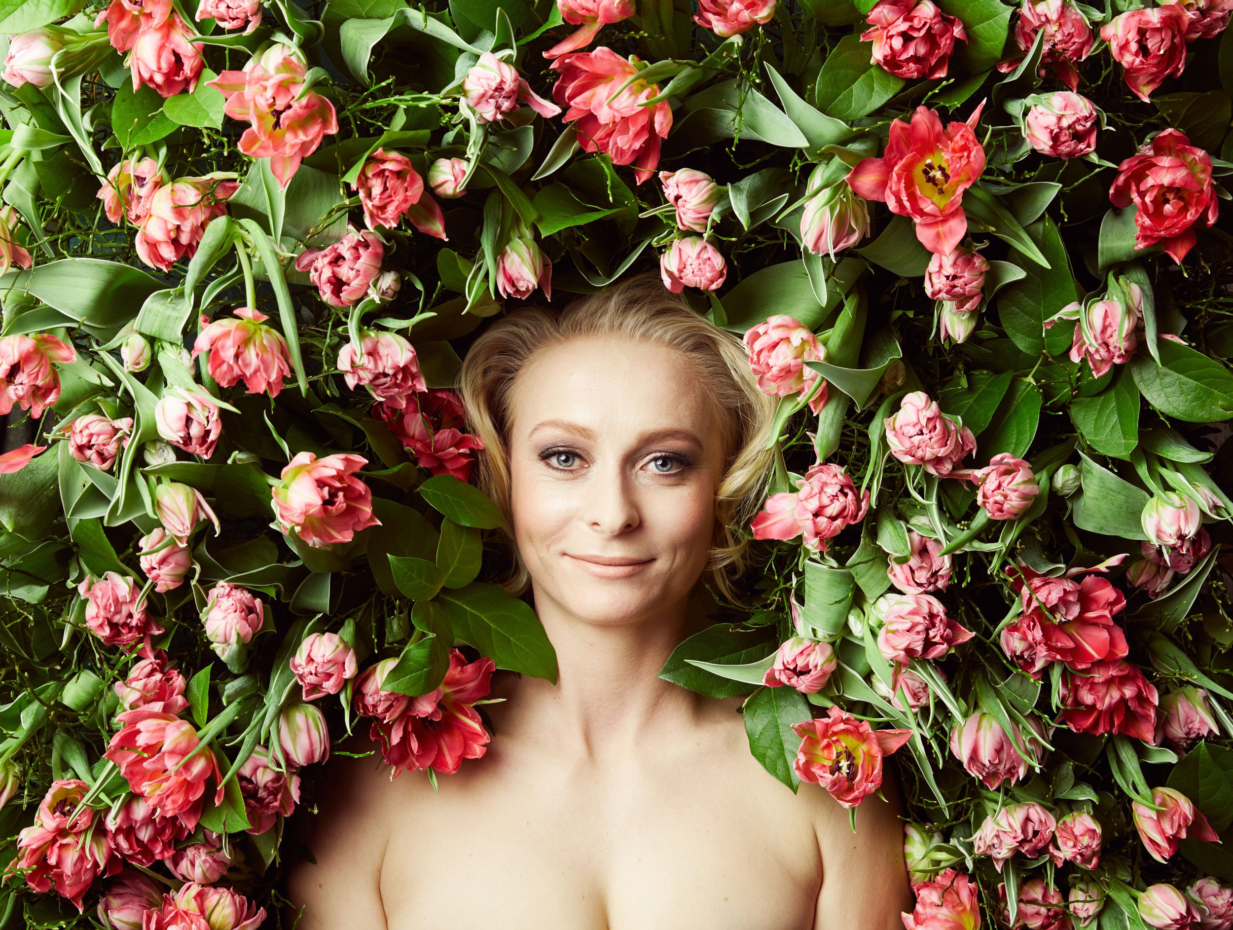 Woman lying surrounded by tulips