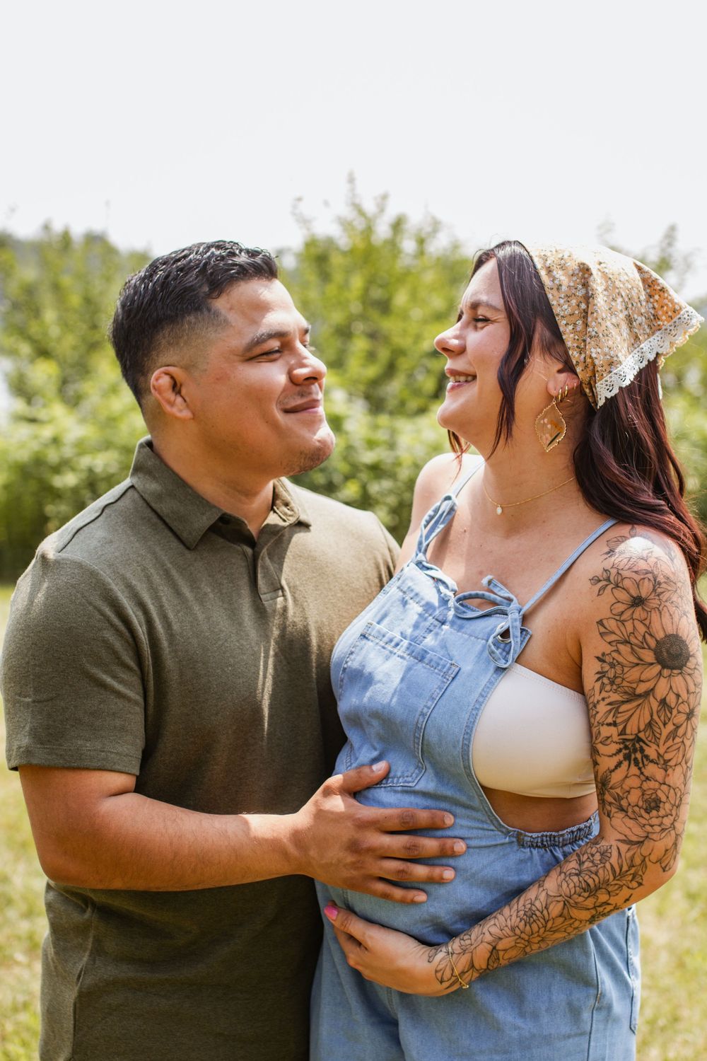 Candid laughter and embraces captured during an outdoor couple's photoshoot.