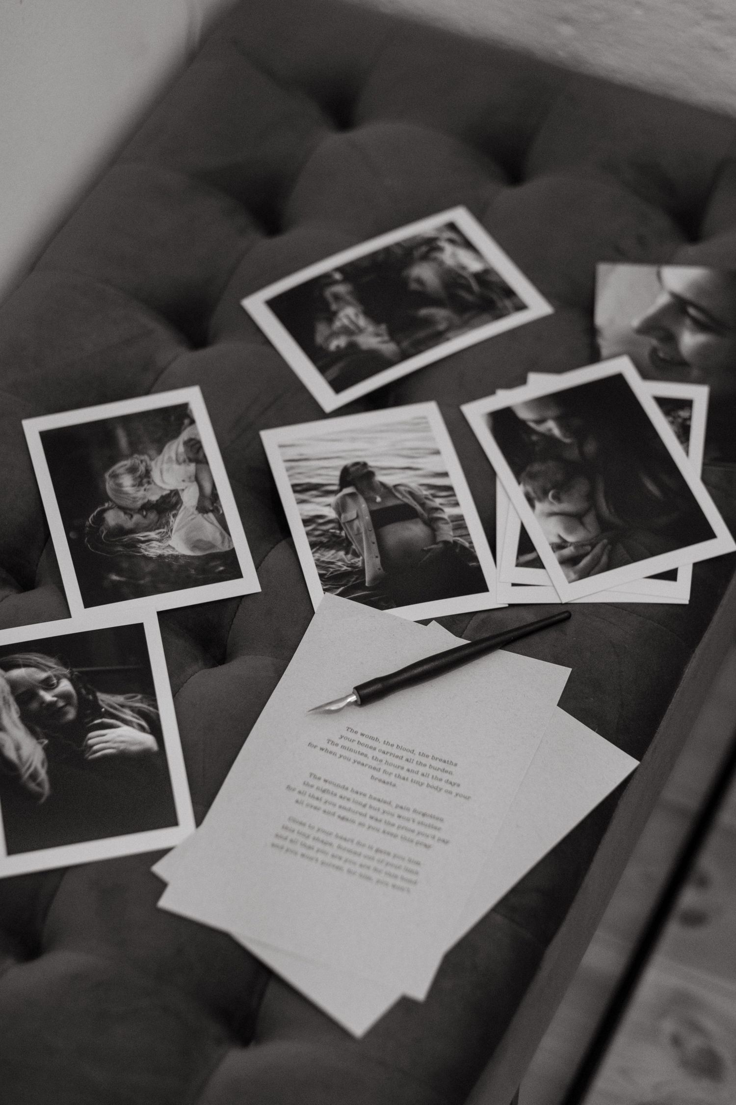 stack of black and white photos and poems arranged in art cafe by newborn photographer in Stockholm