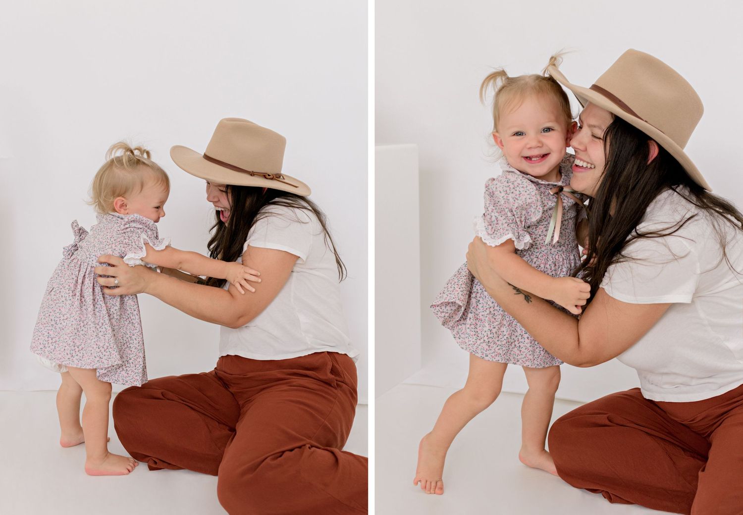 A parent in a beige hat and white shirt plays lovingly with a toddler wearing a pink dress against a white backdrop.