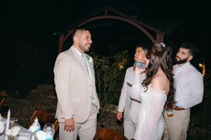 Wedding party gathered outside during nighttime celebration.