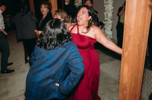 Wedding guests dancing enthusiastically on the dance floor during evening celebration.