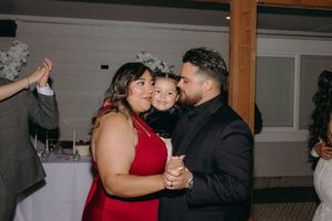 Wedding guests dancing together during a reception celebration indoors.