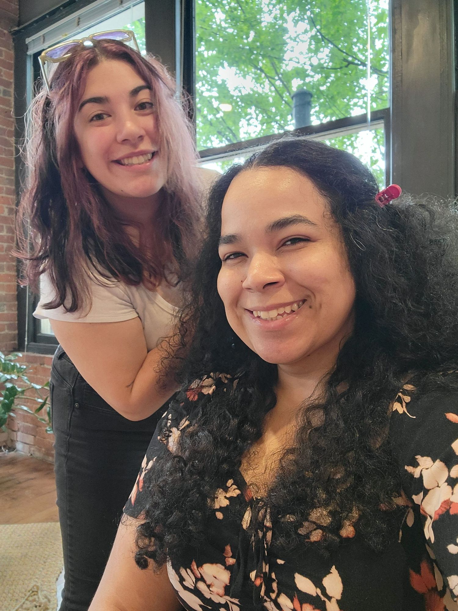 Hairstylist Paige and Seattle photographer Rochelle Marie smiling during behind-the-scenes of a branding session