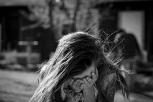Black and white artistic photo capturing wind-blown hair movement.