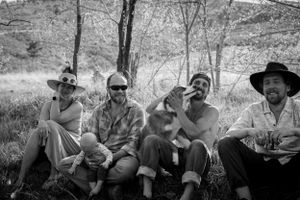 Group of friends relaxing outdoors in black and white photography.