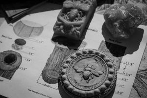 Close-up black and white photo of antique wax seals and stamps on vintage paper.