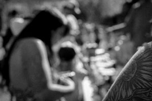 Artistic black and white photo with soft bokeh effect and silhouetted figures.