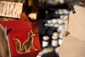 Close-up of a red decorative cat silhouette on display at a market.