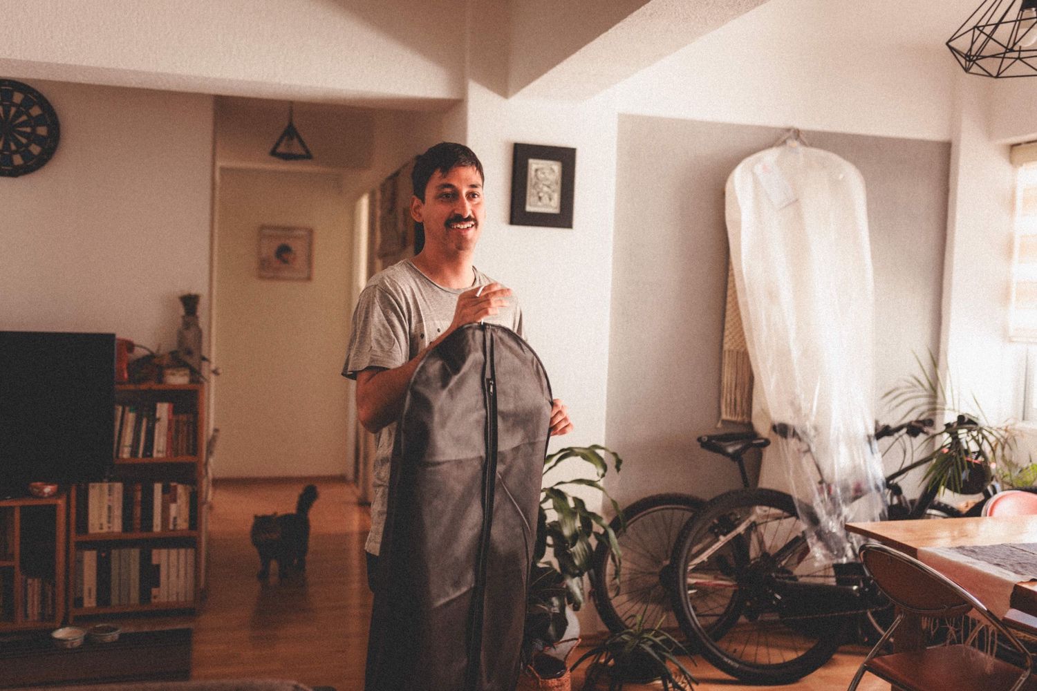 A sequence of interior shots shows a person moving through a sunlit home office space.