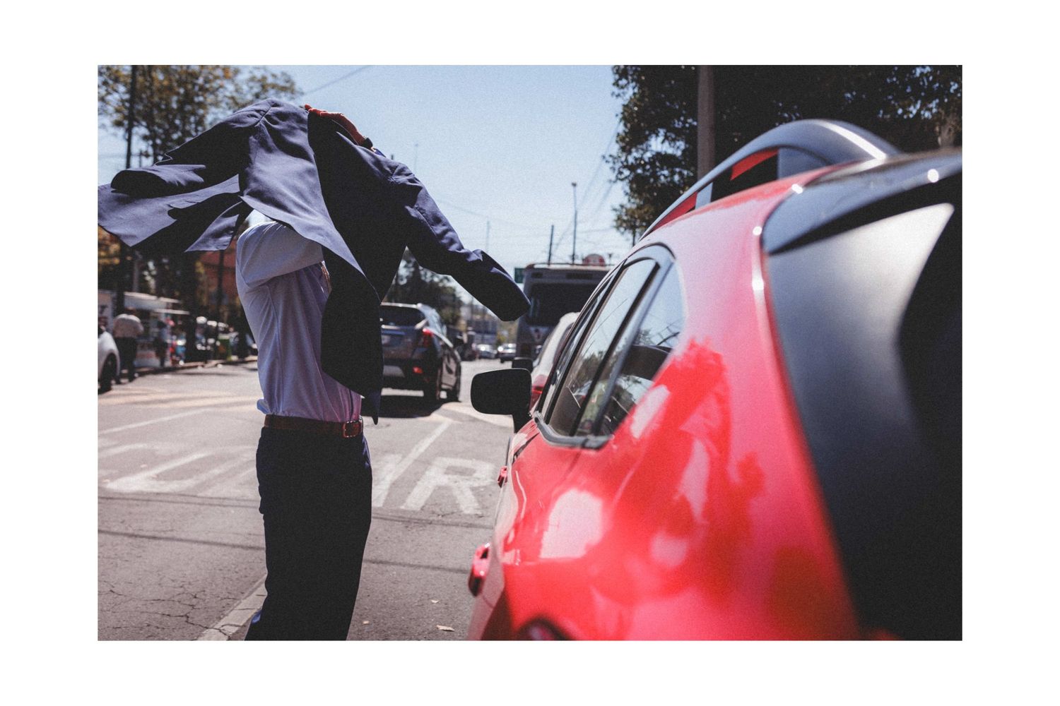 Multiple angles of a red motorcycle parked outdoors during daytime.