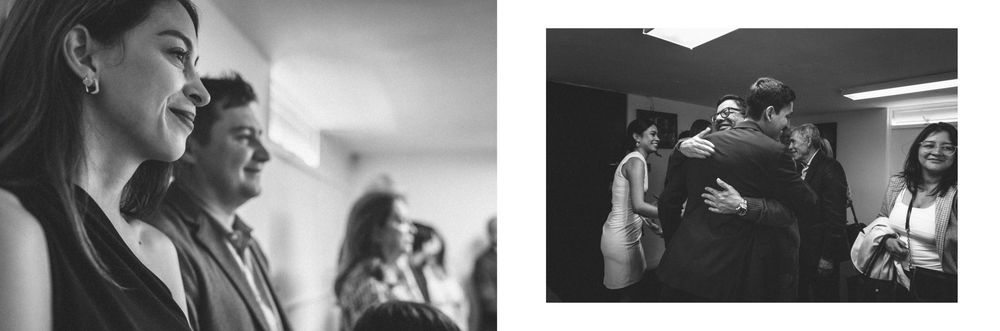 Black and white photo of friends laughing and enjoying a joyful moment together in casual setting.