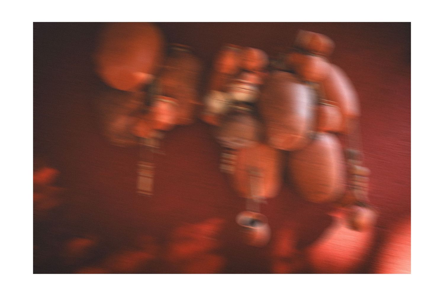 Red glowing orbs appear in a blurry abstract sequence showing motion trails against a dark background.